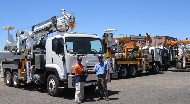 A Director of Ozzy Cranes shaking hands with a customer